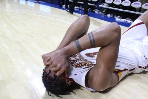Senior guard Myles Burns collapses in tears on the ground right as the time runs out in the NAIA national championship game March 22. Burns was named the games most valuable player in its aftermath.
