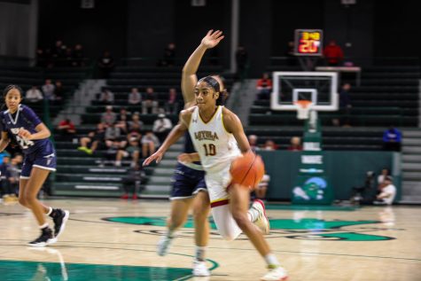 The national championship game is ongoing as Hansberry dribbles across the court with speed so fast the image is blurry around her feet and arms