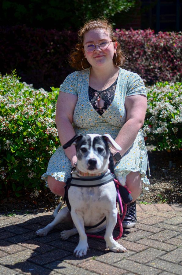 Ángel Seale sits with her service dog, Shiloh, in the Peace Quad, March 25, 2022. Seale said theyve had problems with other students treating her and Shiloh poorly. 