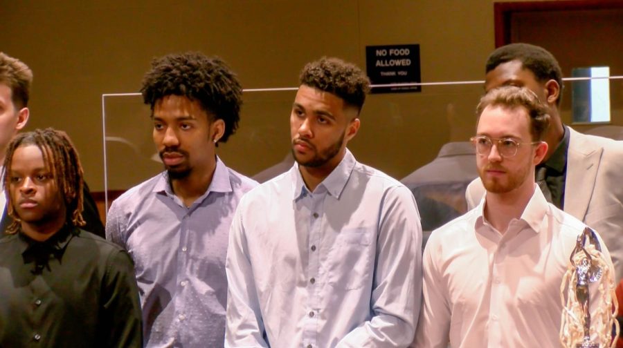 Mens basketball players (left to right) Brandon Davis, Zach Wrightsil, Jalen Galloway, and Andrew Stagni, stand as their team is honored by the New Orleans City Council in City Hall on April 7, 2022. The Loyola mens basketball team won the NAIA National Championship for the first time in 77 years last month. 