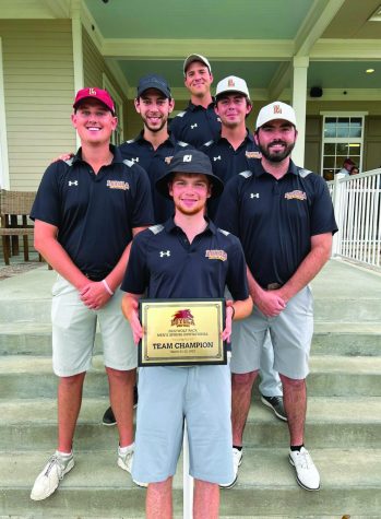 The team stands on the Lakewood Golf Club steps with one player holding the trophy plaque