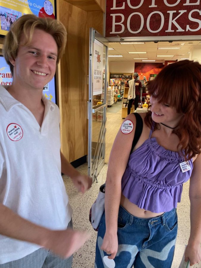 Natalie Butler and her brother wearing stickers and a button which voices student support for a Loyola Sodexo worker union. Students, including Butler, have begun organizing in support of the union. 
