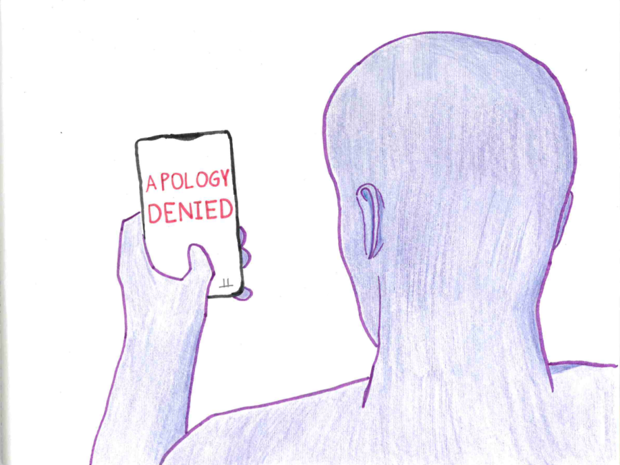 a person reads Apology denied on a cell phone in their hand