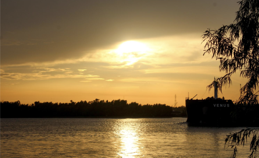 A boat rolls along the Mississippi River as the sun sets on Sept. 4, 2020. Those who lounge near the parks shore can watch boats like this pass by several times in an evening.