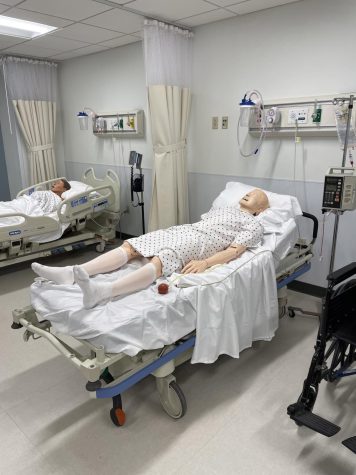 Medical practice mannequins laying on hospital beds Loyolas new simulations lab.