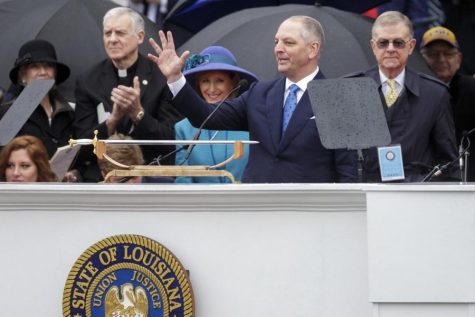 Incumbent governor John Bel Edwards waves to a crowd during his inauguration.