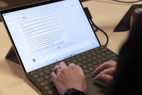 Person using Artificial Intelligence software on their computer to complete their work.