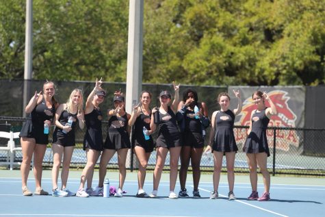 The womens tennis team stands for a group photo during their match against Jones College at City Park Tennis Center on March 22, 2023