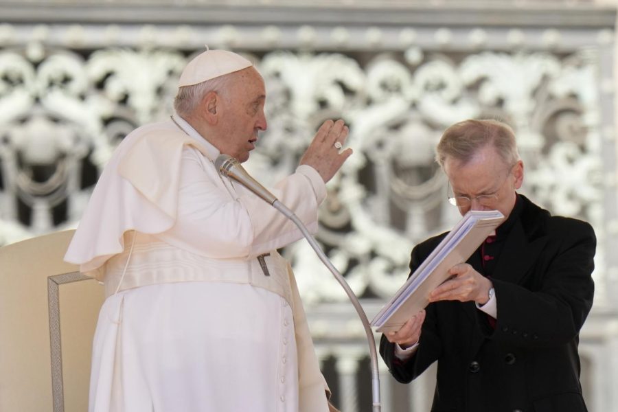 Pope Francis reading off text.
