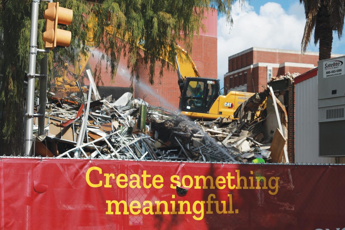 An excavator continues destruction of Mercy Hall after a month of construction on Aug. 14. Mercy Residence Hall will replace the building in fall of 2025.