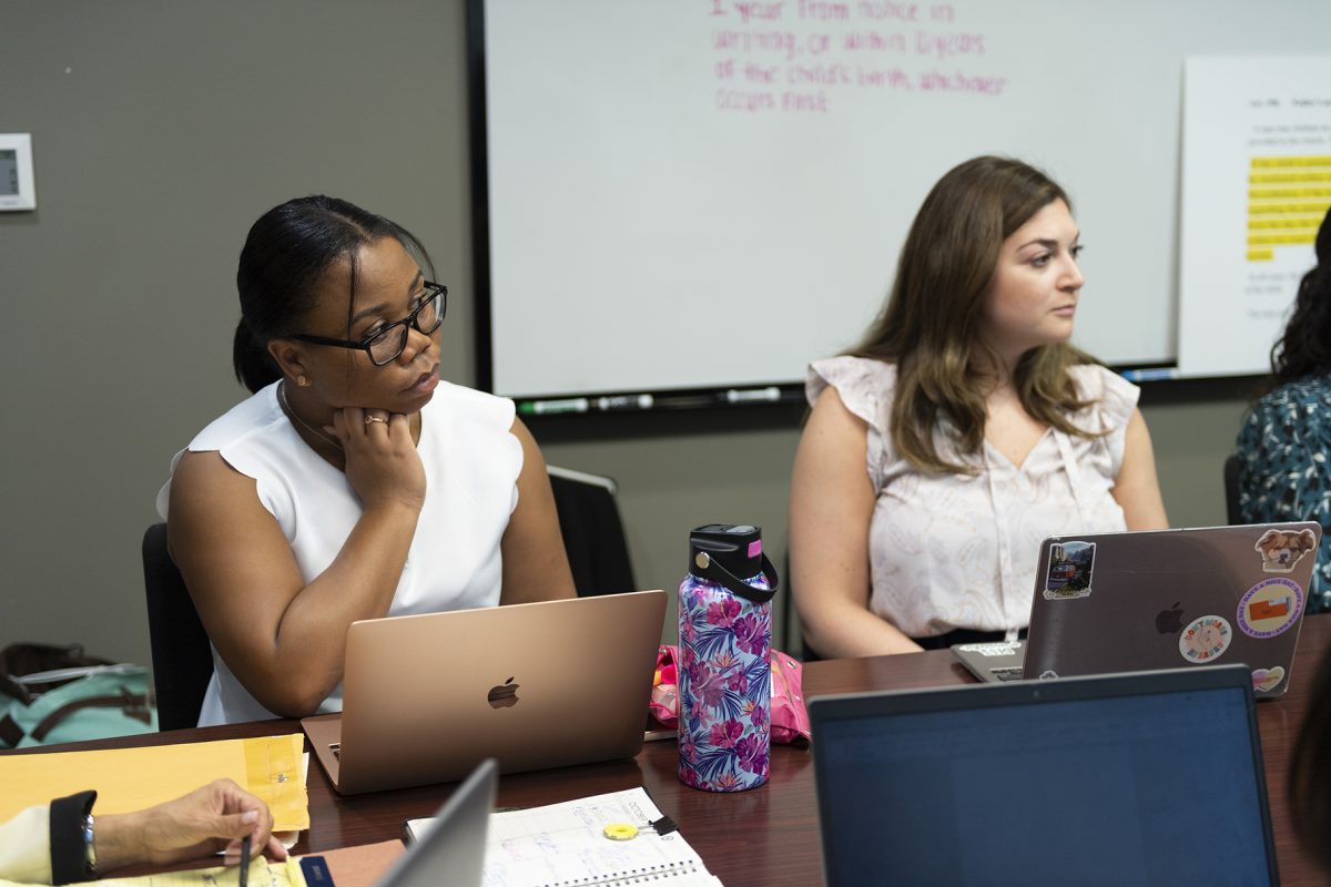 Two law students work at the Loyola law school for the Gillis Long Poverty Law Center. The center provides free legal aid to individuals in need. 