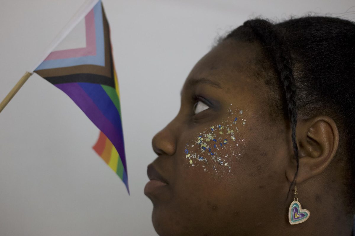 Design junior Tanesha Taylor looks at progress pride flag. 