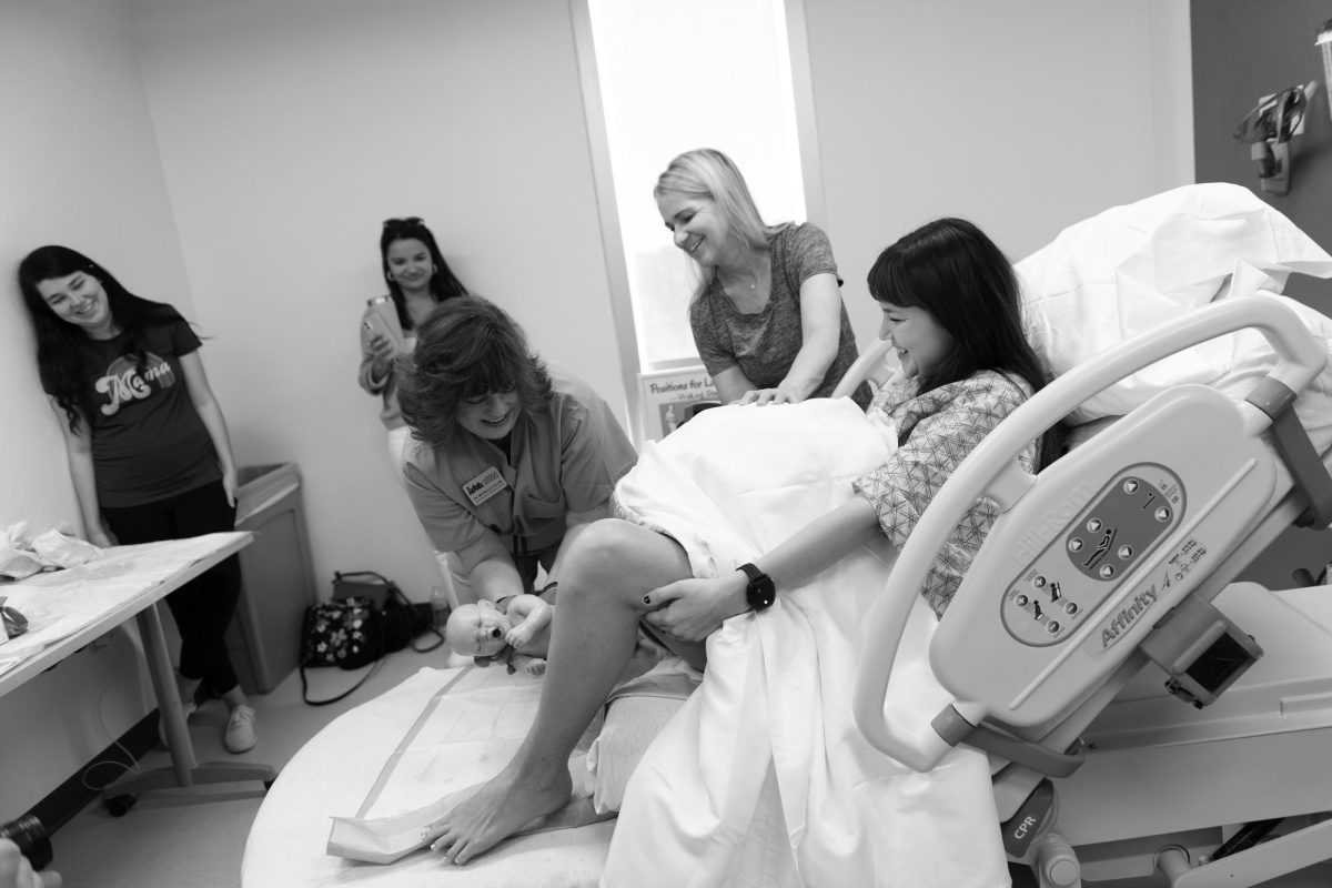 Dean of the College of Nursing and Health, Michelle Collins, simulating a vaginal delivery with our Avkin wearable birth simulator at the Nursing Simulation Day Open House in spring, 2023. Loyolas midwifery program addresses a need within the community of high infant mortality rates. Courtesy of the College of Nursing and Health.