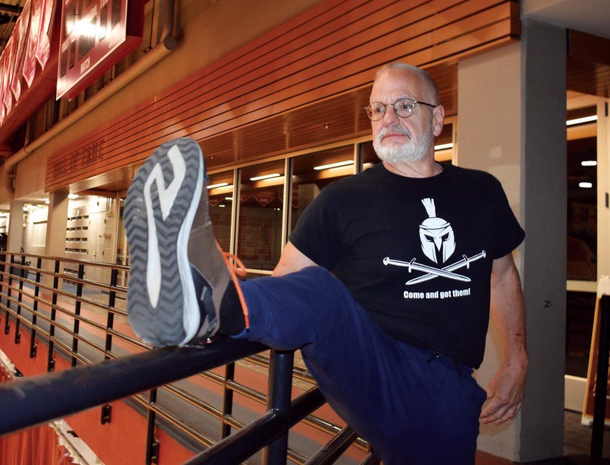 Herbert Kiff stretches on the railing, his unofficial ballerina bar on March 6, 2024. Kiff comes to the sports complex about 4 times a week.

[The space] means a lot he said. Its neat, its clean, they do a good job with it. I come here to weight-lift. I do my exercises, and I do cardiovascular and stretching and everything else.