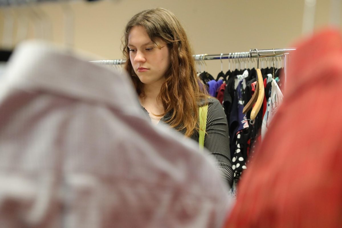 English sophomore Elinor Upham searches the racks of Wolfpack Wardrobe.
