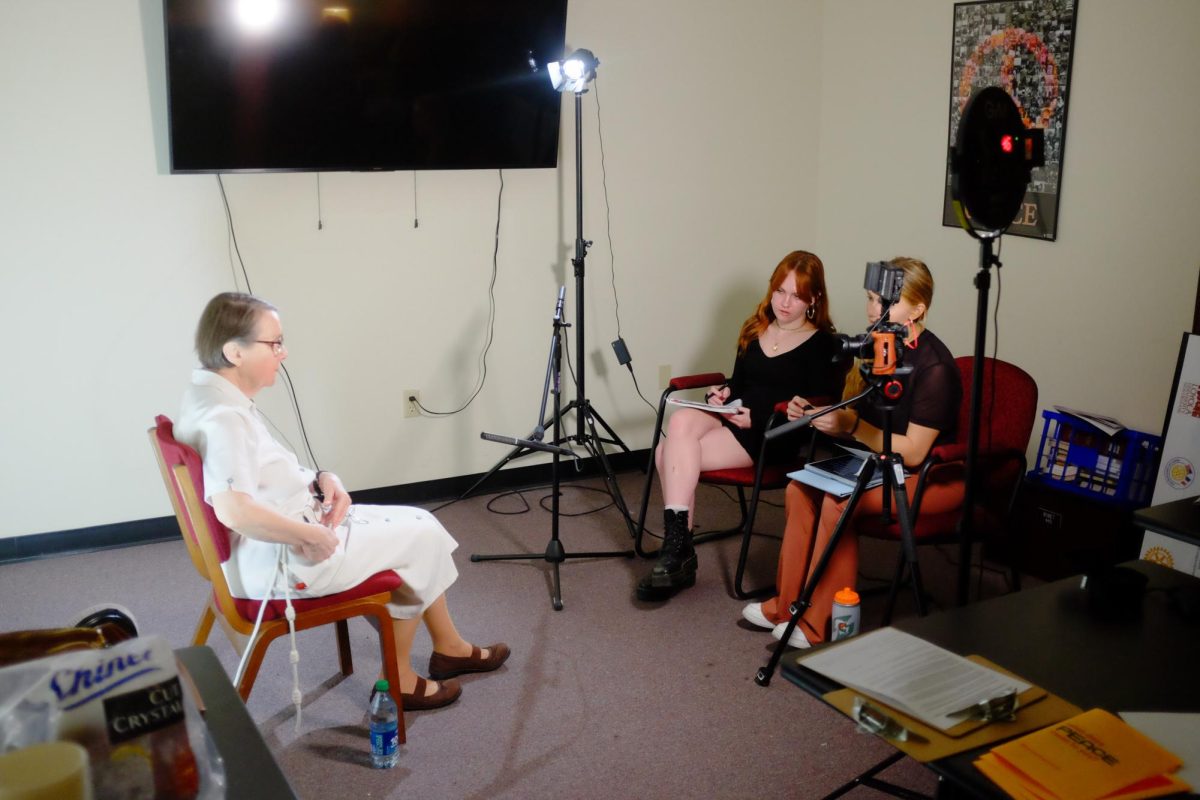 Charlotte Berg and Ava Radosevich interview Sr. Julie Glaeser in Bobet Hall on April 2, 2024. Students taking Documentary and Oral Histories with professor Justin Nystrom are curating a podcast. Courtesy of Justin Nystrom