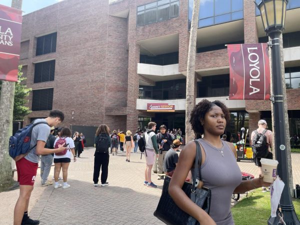 Students wait outside of the communications and music building during a power outage on April 16, 2024.