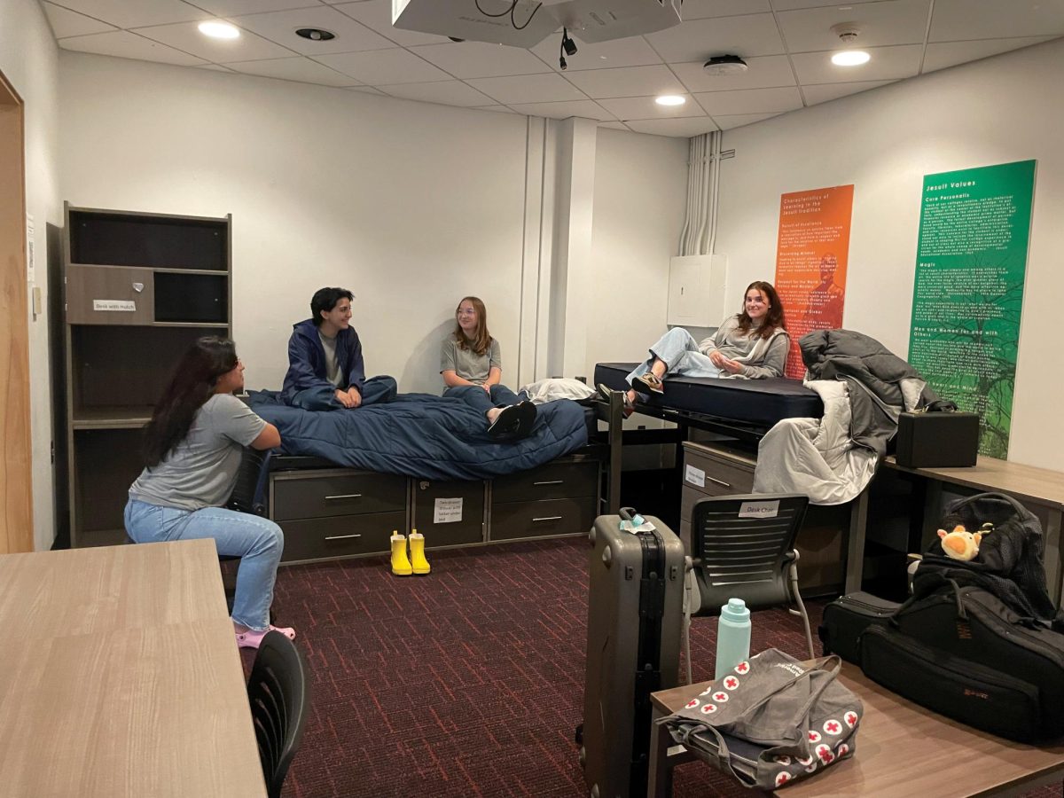 (L-R): Daisy Trigueros, Gabi Salinas, Nora Humfeld, and Willa Rudnick try out furniture in the One Loyola Room on April 10, 2024. Residential Life is deciding on furniture for the new residence hall.
