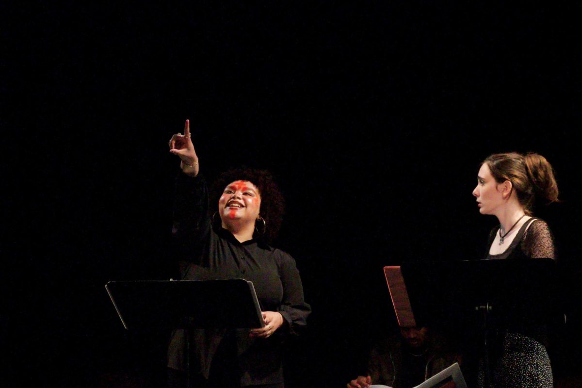 Enne Samuels (God) points during reading of A New Saint for a New World alongside Amanda Greenbaum (Wall) on April 6, 2024 in the Lower Depths Theater.