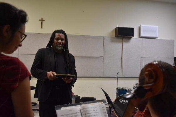 Navigation to Story: Professor conducts music with spirit and kindness