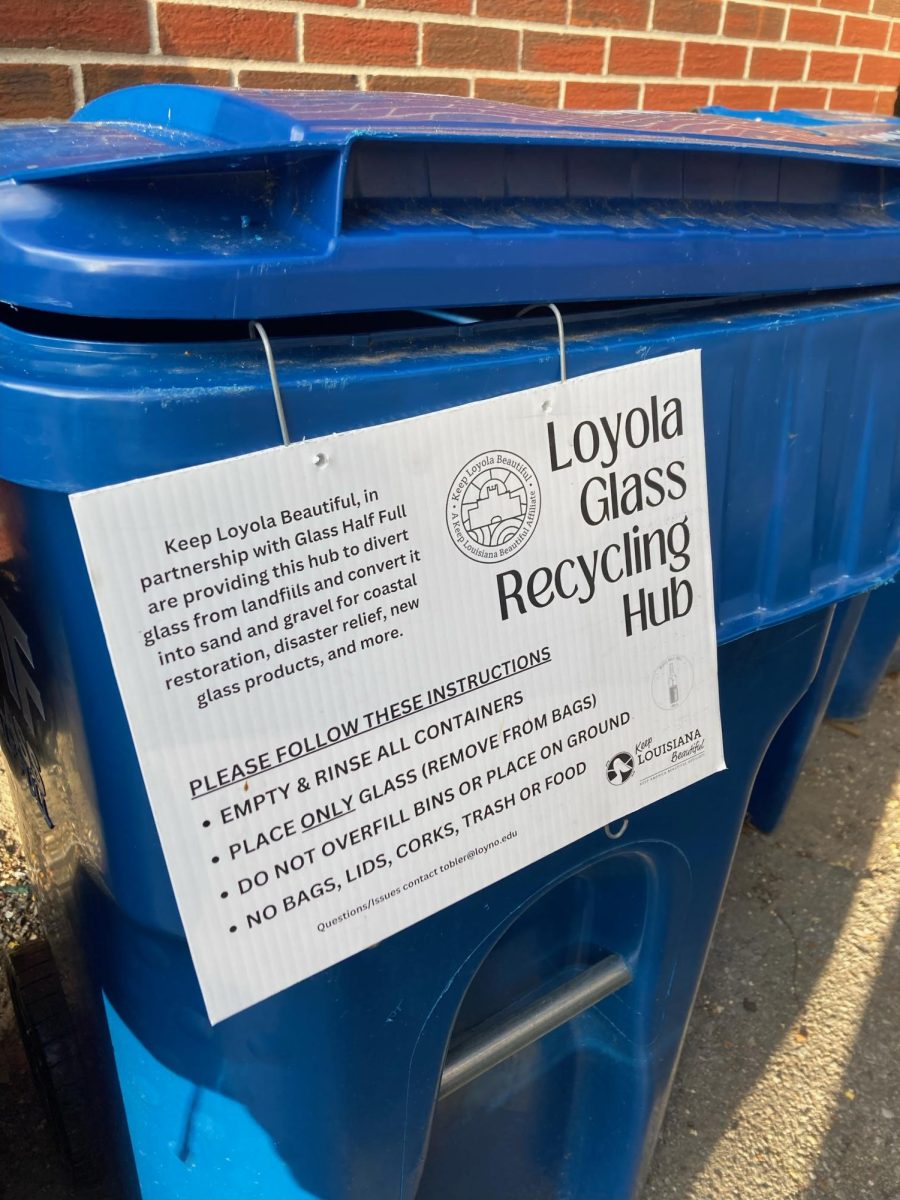 Glass recycling bin located behind the Danna Center, with signage stating recycling instructions. This bin was put in place through Keep Loyola Beautiful's partnership with Glass Half Full.