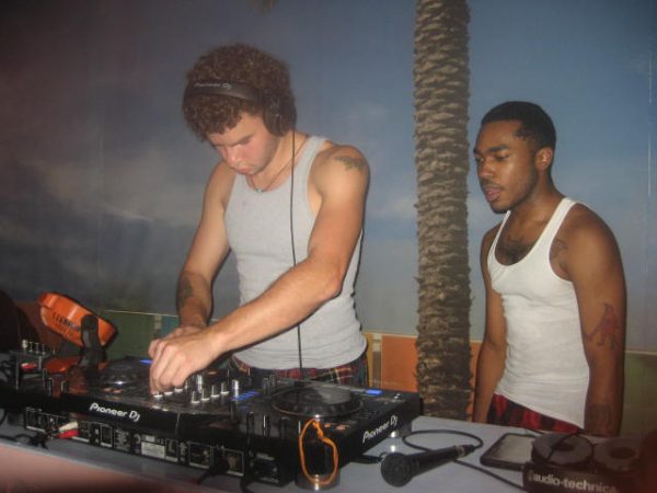 DJ: Zev Russ (left) and Kenneth Preyear (right) share a moment behind the DJ booth during a set at a pajama themed rave at Black and Gold Wash and Fold on 08/24/2024.