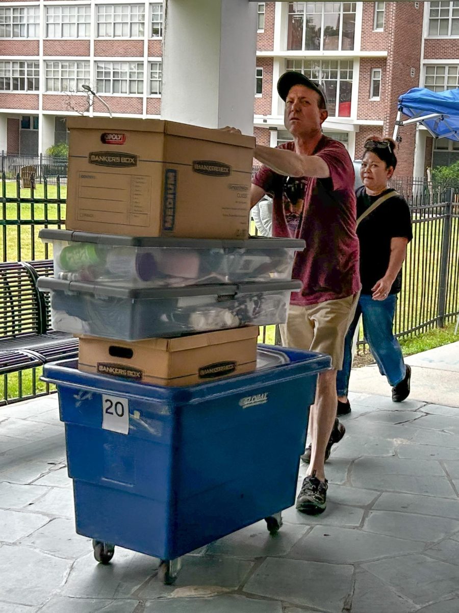 Parent helps student move into dorm. New student enrollment has gone down when compared to previous years.