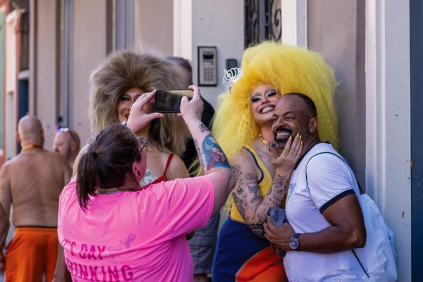 Fan takes photo with local drag personality on Royal Street.