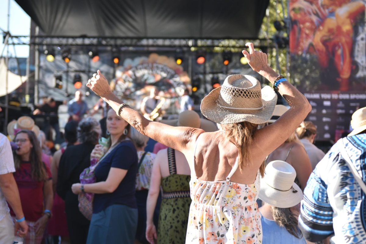 Festival goers gather and dance around the main stage.