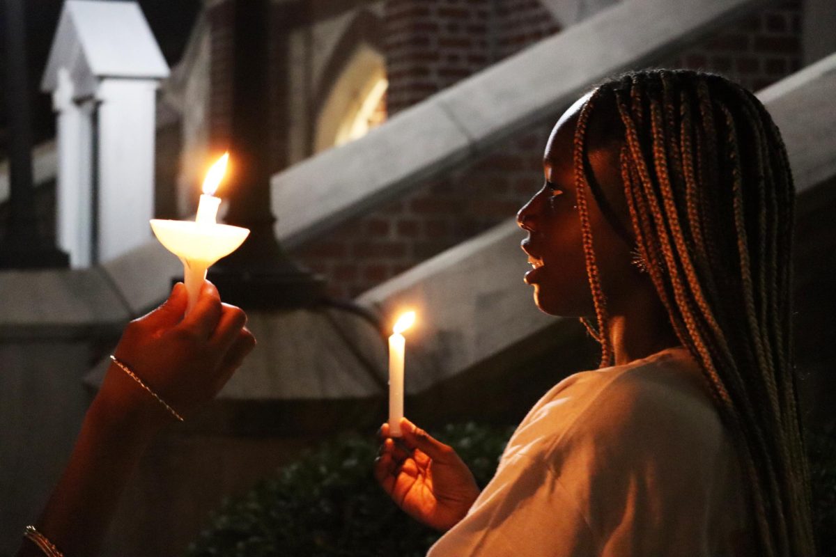 Student holds candle vigil in support of sexual assault survivors on Oct. 21.