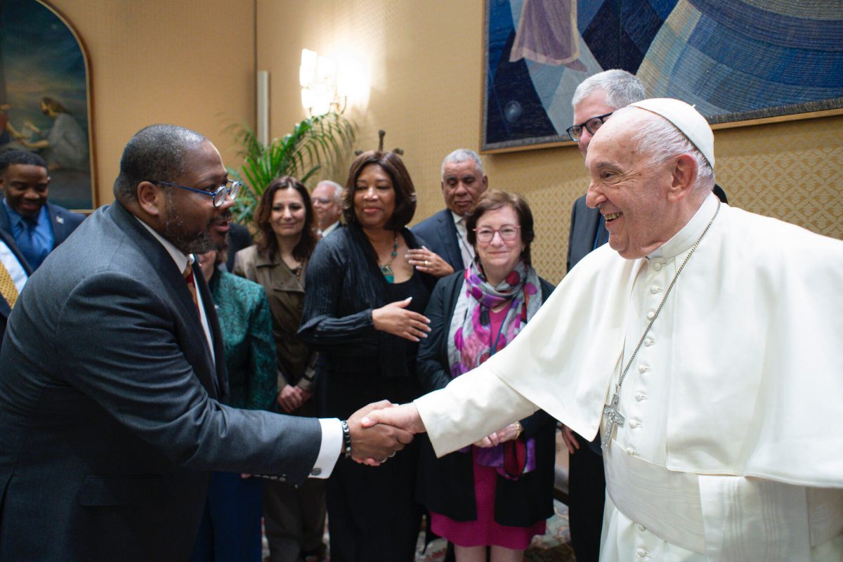 Loyola President Xavier Cole shakes hands with Pope Francis. Courtesy of Cole