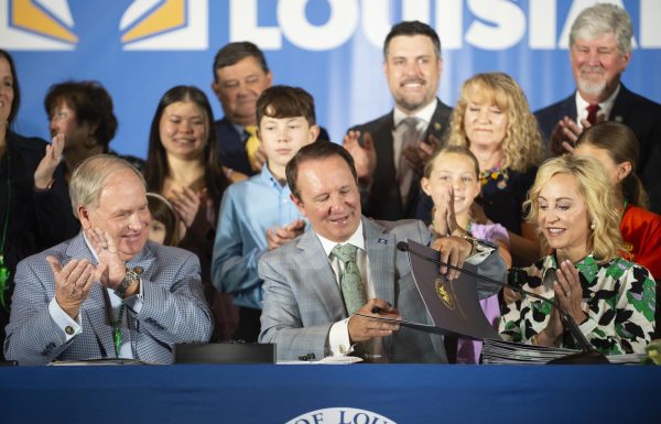 Louisiana Gov. Jeff Landry signs bills related to his education plan, Wednesday, June 19, 2024, at Our Lady of Fatima Catholic School in Lafayette, La. Civil liberties groups filed a lawsuit Monday, June 24, challenging Louisiana’s new law that requires the Ten Commandments to be displayed in every public school classroom. Photo courtesy of AP.