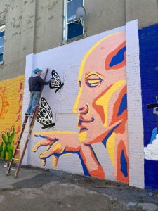 Bladon finishing his mural for the 2023 art festival, Paint Memphis. Courtesy of Tate Bladon.