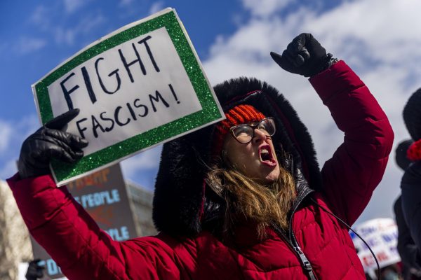 Christina Sears of Ypsilanti shouts out against President Donald Trump along with hundreds of people gathered at the steps of Michigan's Capitol, Monday, Feb. 17, 2025 in Lansing, Mich. (Jake May/The Flint Journal via AP)