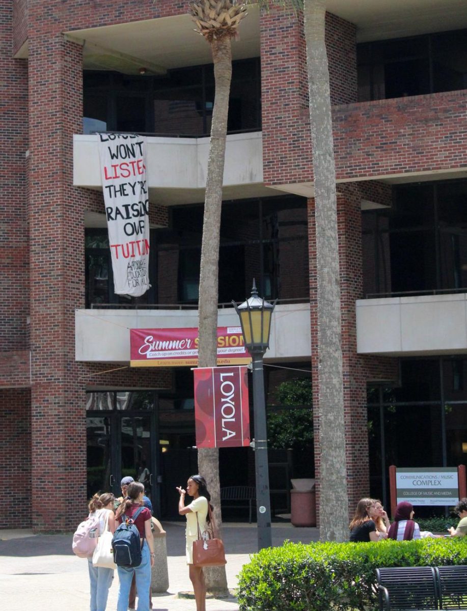 Loyola students drop a banner the Communications/Music Complex criticizing tuition raises on April 29, 2025. Loyola University New Orleans plans to raise tuition prices for all students. 