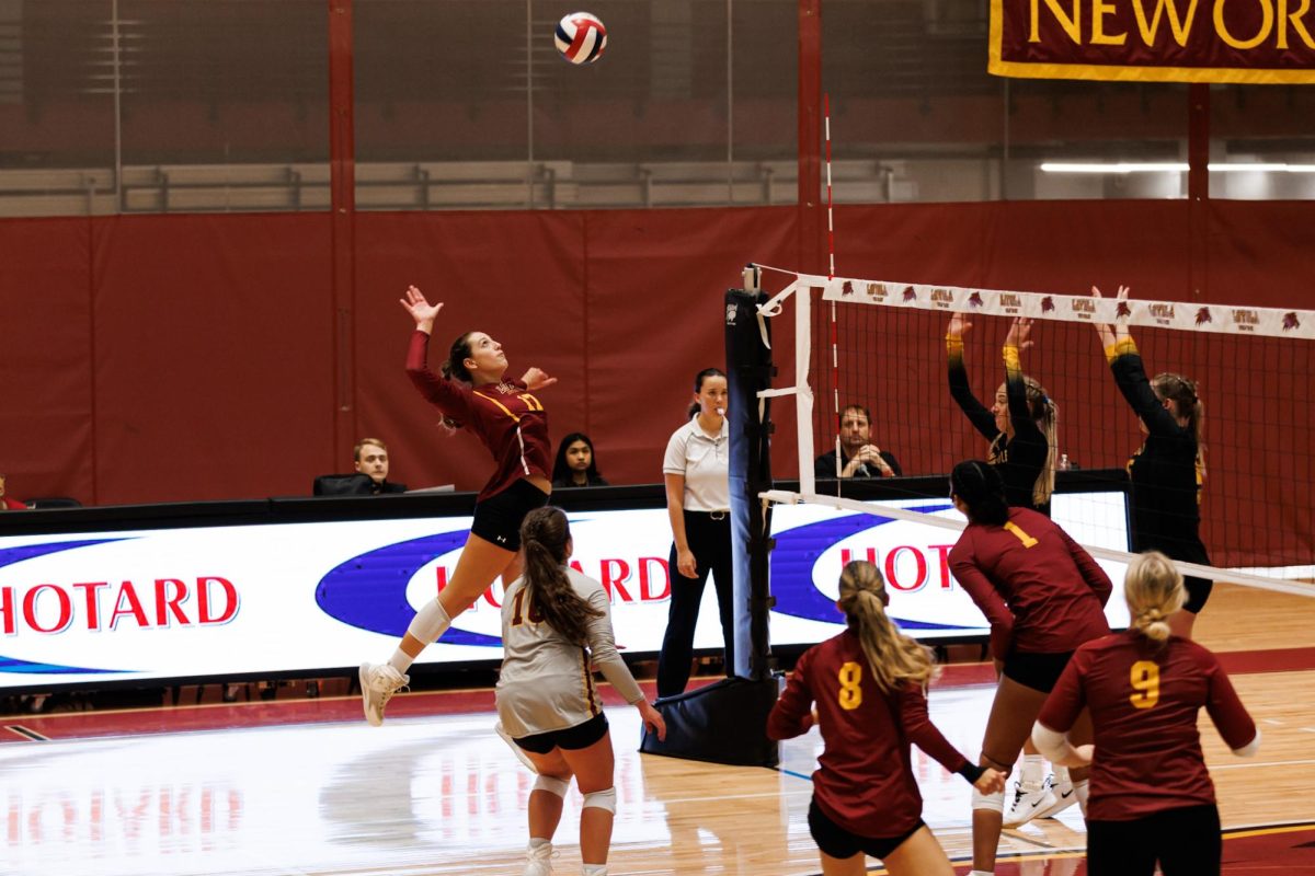 Samantha Guillotte spiking a volleyball at a game. Abby Smith/ Loyola Univeristy New Orleans Atheltics
