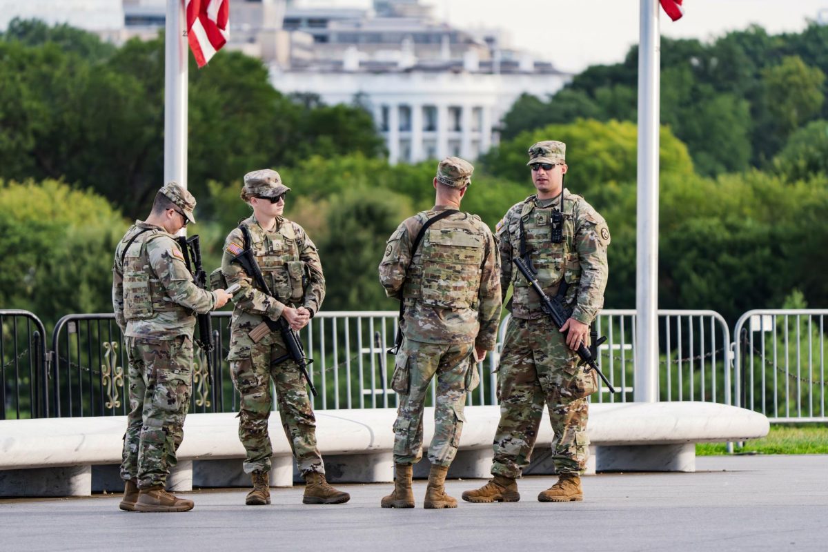 With the White House in the distance, National Guard troops patrol the Mall as part of President Donald Trump's order to impose federal law enforcement in the nation's capital, in Washington, Aug. 28, 2025. 