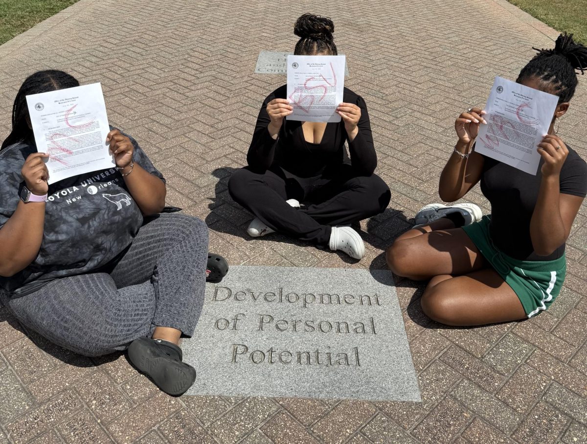 Three people holding letters for Attorney General's Office calling for new changes to three organizations on campus. These three orgs include Black Student Union, Women's Resource Center, and Multiple Cultural center.
