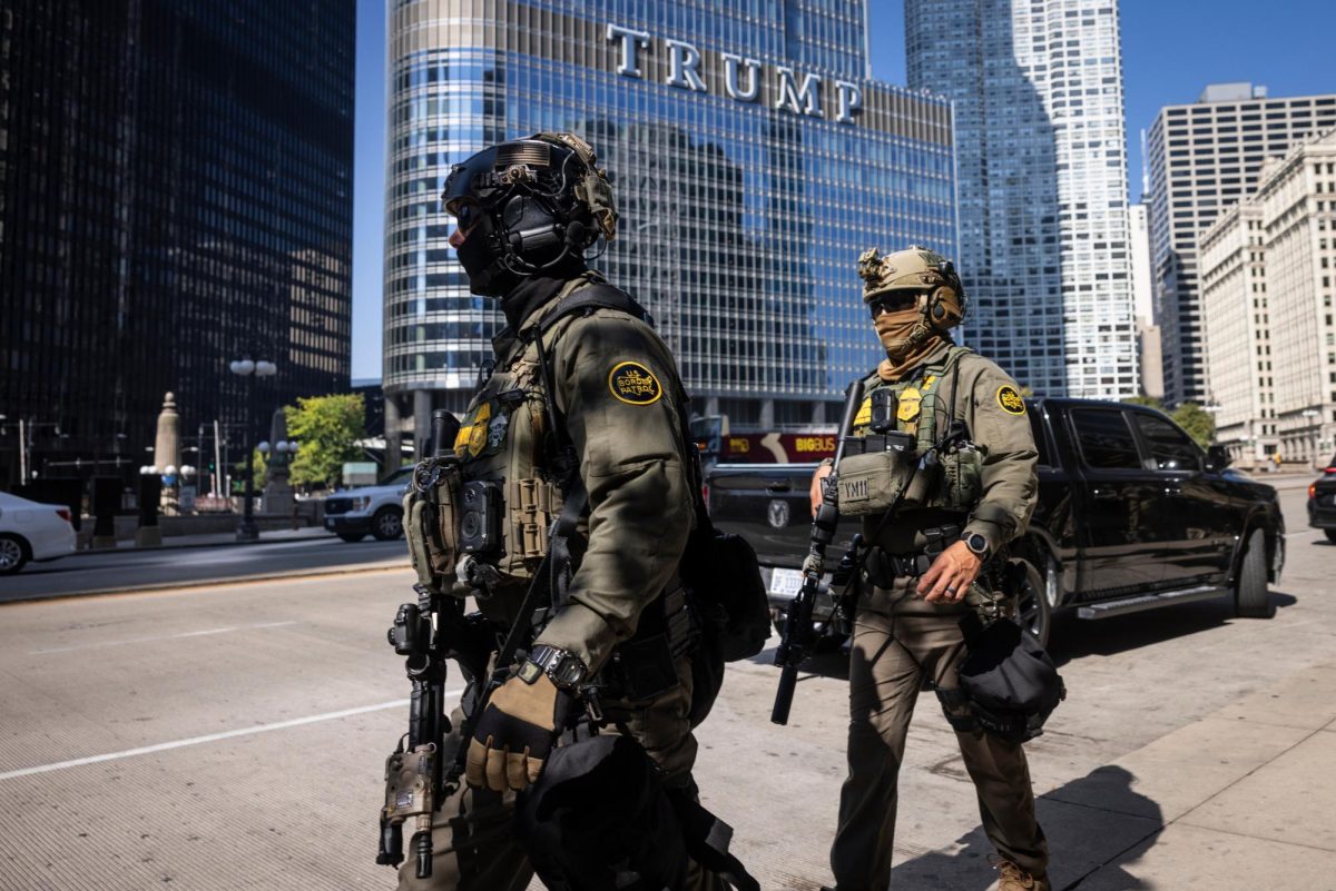 Federal agents from U.S. Immigration and Customs Enforcement and U.S. Customs and Border Protection walk along West Wacker Drive in the Loop, Sunday, Sept. 28, 2025, in Chicago.