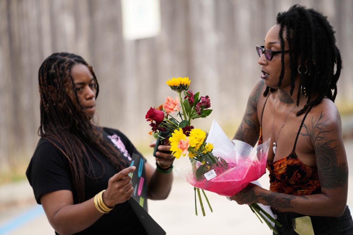 Moonlight Phillips, right, and Victoria Williams, members of the Louisiana Coalition for Reproductive Freedom, arrive at Planned Parenthood on the day they are closing, to deliver cards and flowers to the organization, in New Orleans, Tuesday, Sept. 30, 2025.