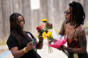 Moonlight Phillips, right, and Victoria Williams, members of the Louisiana Coalition for Reproductive Freedom, arrive at Planned Parenthood on the day they are closing, to deliver cards and flowers to the organization, in New Orleans, Tuesday, Sept. 30, 2025.