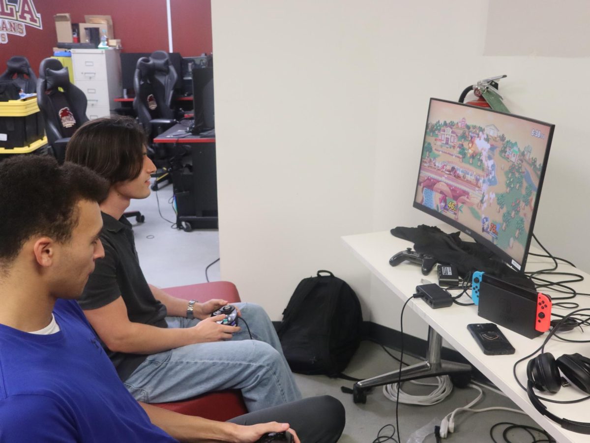 Sam Spiegel and Malachi Lee playing a round of Super Smash Bros. during Loyola's esport practice. The team meets regularly to sharpen skills and build teamwork. Qemyne Barnes/The Maroon.