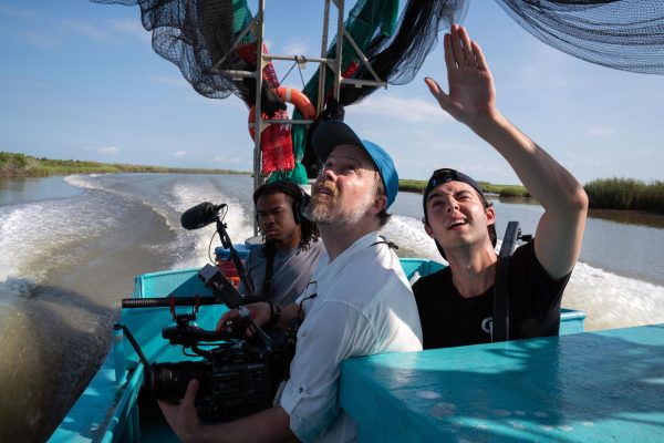 Presson shoots a scene for the documentary on a shrimping boat in the Gulf of Mexico. Photo courtesy of Rory Doyle.