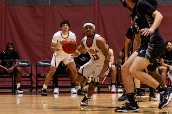 Kameron Johnson dribbling the ball in the middle of a play. The team recently played Texas A&M San Antonio. Courtesy of Abigail Smith / Loyola New Orleans Athletics