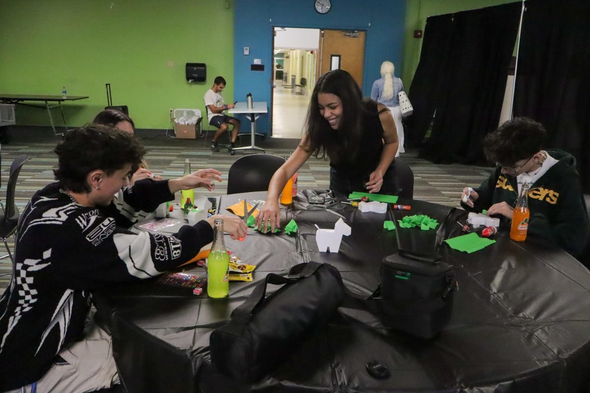 Left to right: Damian Ch, Natalia Ruiz, Hannah Mebarak, and Alan Ch decorate their piñatas at the UPB piñata decorating event. 