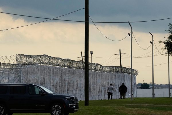 Security walk outside "Camp 57," a facility to house immigration detainees at the Louisiana State Penitentiary in Angola, La., on Sept. 3, 2025.