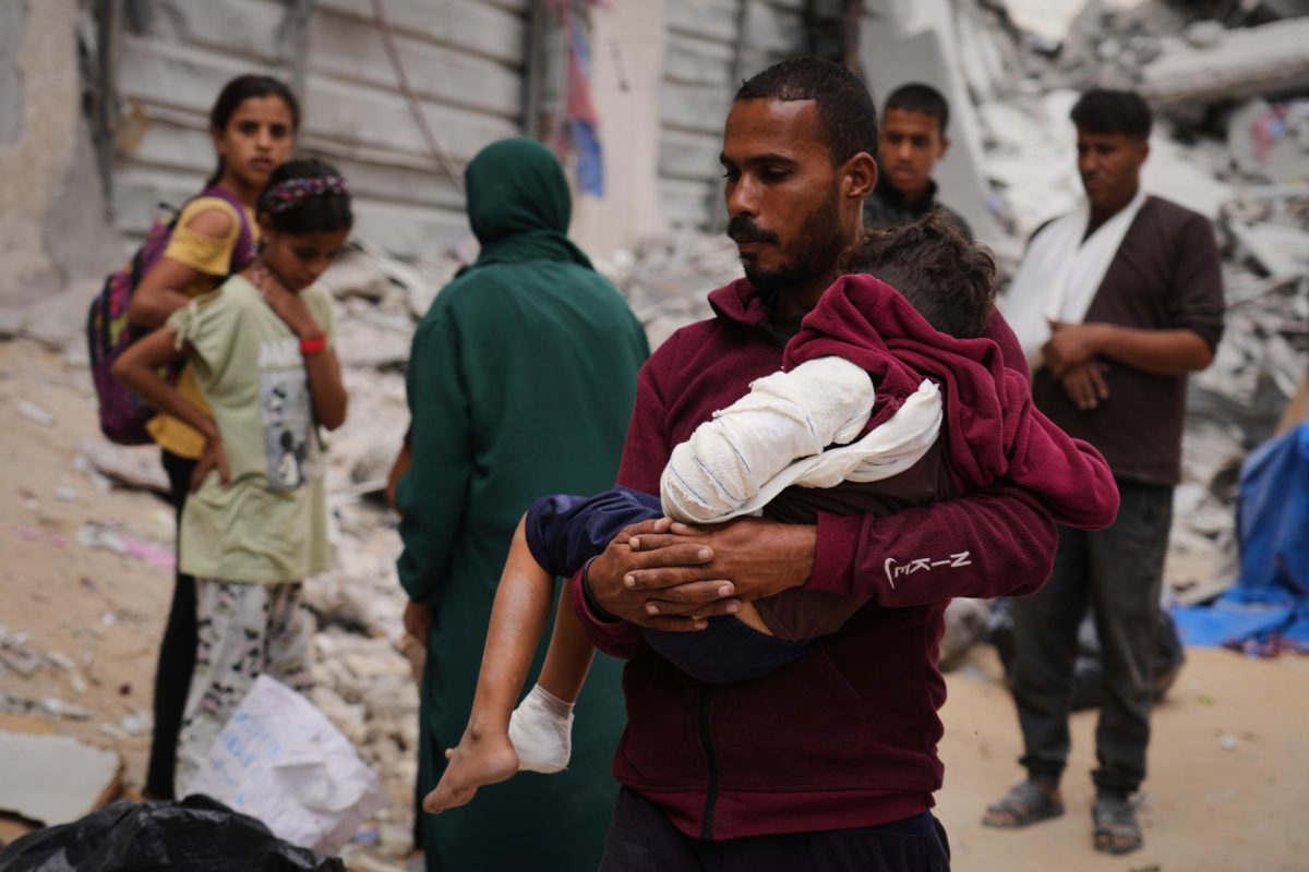 A man carries a child injured in an Israeli strike in Khan Younis, Gaza Strip, Wednesday, Oct. 29, 2025. 