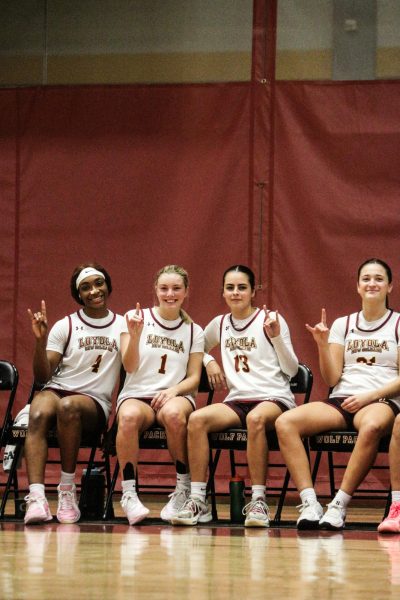 Jada Washignton , Addison Luker, Isabella April, and Taylor Smith holding up the wolf pack hand sign during home game on the sidelines. They have recently won thier first two home game.  Courtesy of Heidi Herrera-Wanke