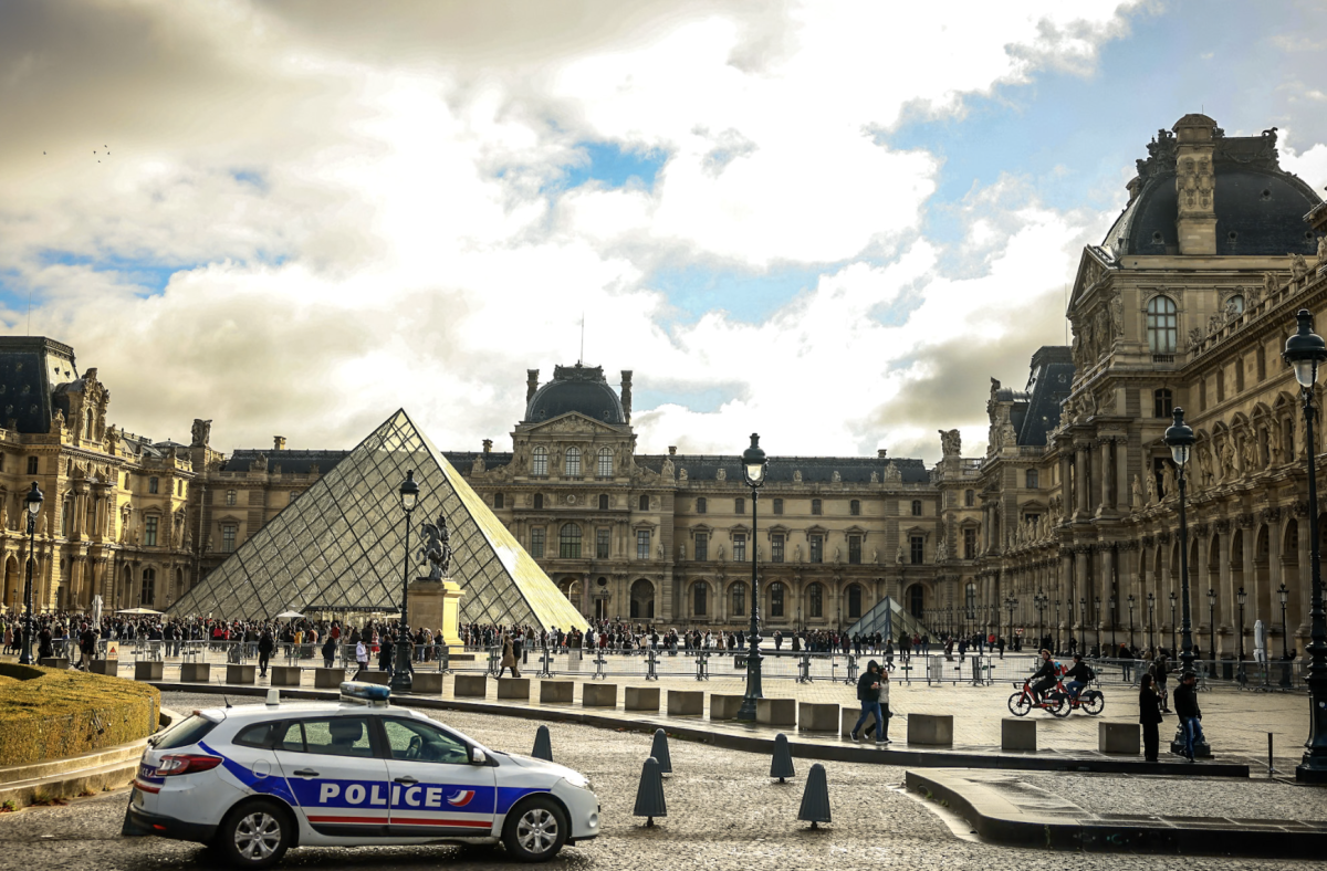 A police car parks in the courtyard of the Louvre museum, one week after the robbery, Sunday, Oct. 26, 2025 in Paris. The Paris prosecutor said on Sunday that a number of suspects have been arrested over the theft of crown jewels from Paris' Louvre museum last weekend. (AP Photo/Thomas Padilla)