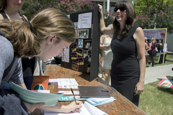 Patricia Boyett tells Audrey O'Connel about the Women's Resource Center at the Student Organization Fair. The fair was an opportunity for students to learn about organizations they can be involved with on campus. Photo credit: Taylor Galmiche